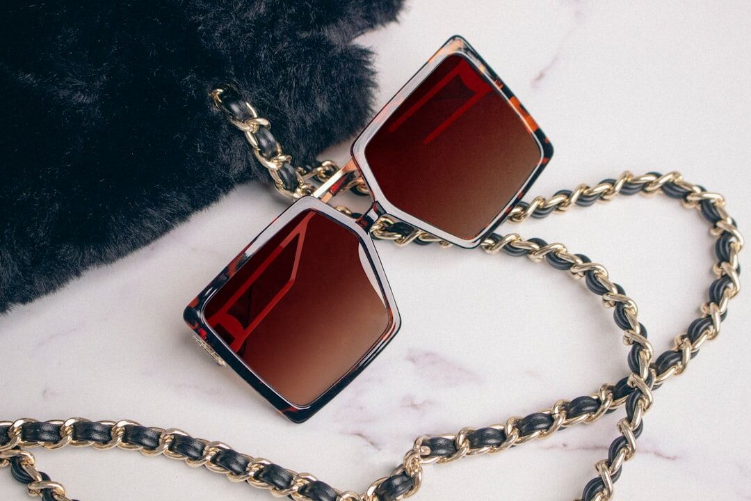 Designer sunglasses with bold acetate frame on marble